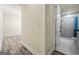 Hallway with wood floors leading to a modern bathroom with stylish fixtures at 140 Wesley Pl, Fayetteville, GA 30214
