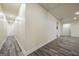 Long hallway with wood-look floors leads to other finished spaces of the basement at 140 Wesley Pl, Fayetteville, GA 30214