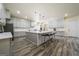 Open kitchen with stainless steel appliances, a large island, and ample cabinet space at 140 Wesley Pl, Fayetteville, GA 30214