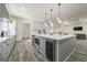 Elegant kitchen island featuring a wine cooler, built-in microwave, and white countertops at 140 Wesley Pl, Fayetteville, GA 30214