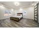Spacious main bedroom with gray wood floors, tray ceiling and a barn door to the ensuite bathroom at 140 Wesley Pl, Fayetteville, GA 30214