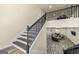 Staircase with wood and white risers, black metal spindles, and a view of the living room at 140 Wesley Pl, Fayetteville, GA 30214