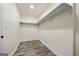 Bright walk-in closet with wood floors, white trim, and shelving to maximize storage at 140 Wesley Pl, Fayetteville, GA 30214
