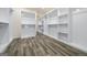 Large, empty walk-in closet with wood floor and ample shelving and hanging space at 140 Wesley Pl, Fayetteville, GA 30214