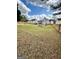 Vast backyard with a wooden fence, bench, and well-maintained lawn, perfect for outdoor enjoyment at 55 Long Dr, Covington, GA 30016