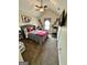 Bedroom featuring neutral carpeting and decor, with a ceiling fan and ample natural light at 55 Long Dr, Covington, GA 30016