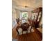 Elegant dining room with a chandelier, hardwood floors, and a formal dining set at 55 Long Dr, Covington, GA 30016