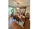 Formal dining room features an ornate chandelier, hardwood floors, and lovely china cabinet at 55 Long Dr, Covington, GA 30016