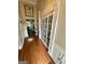 Elegant entryway featuring hardwood floors, white wainscoting, and a glimpse into the kitchen at 55 Long Dr, Covington, GA 30016