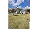 Two-story home with a green lawn and mature tree in the front yard at 55 Long Dr, Covington, GA 30016