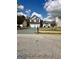 Inviting two-story home with a two-car garage, showcasing its landscaped front yard and charming design at 55 Long Dr, Covington, GA 30016