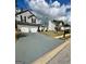 Attractive exterior view of a two-story house featuring a spacious driveway and well-manicured front lawn at 55 Long Dr, Covington, GA 30016