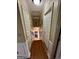 Hallway featuring hardwood floors, white trim, and natural lighting at 55 Long Dr, Covington, GA 30016