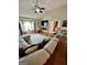 Bright and open living room featuring comfortable seating, a fireplace, and views of the backyard at 55 Long Dr, Covington, GA 30016
