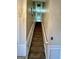 Carpeted staircase with white railing leading to the upper level at 55 Long Dr, Covington, GA 30016