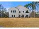 Stunning modern farmhouse with vertical siding and large windows, offering a contemporary and bright living space at 130 Wesley Pl, Fayetteville, GA 30214