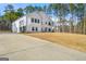Modern farmhouse exterior with a long driveway and well-maintained lawn at 130 Wesley Pl, Fayetteville, GA 30214