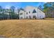 Bright white modern farmhouse exterior with well-maintained lawn, offering curb appeal at 130 Wesley Pl, Fayetteville, GA 30214