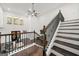 Open Foyer with stairs featuring iron railing overlooking living room with cozy seating area at 130 Wesley Pl, Fayetteville, GA 30214