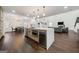 Open concept kitchen with a large island, stainless steel appliances, and adjacent dining and living areas at 130 Wesley Pl, Fayetteville, GA 30214