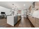 Bright, open kitchen with island, stainless steel appliances, wood cabinets, and an adjacent living area at 130 Wesley Pl, Fayetteville, GA 30214