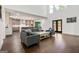 Bright, open living room with hardwood floors, modern furniture, and an eat-in kitchen in the background at 130 Wesley Pl, Fayetteville, GA 30214