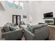 Bright living room with high ceilings, large windows, and comfortable seating around a modern fireplace at 130 Wesley Pl, Fayetteville, GA 30214