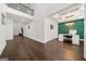 Open living space with hardwood floors, adjacent to an office with stylish green accent wall at 130 Wesley Pl, Fayetteville, GA 30214
