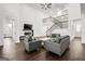 Spacious living room featuring a staircase, a fireplace, and two gray couches at 130 Wesley Pl, Fayetteville, GA 30214