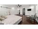 A spacious main bedroom with hardwood floors, a ceiling fan, and a sliding barn door at 130 Wesley Pl, Fayetteville, GA 30214