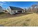 Spacious backyard with a grassy slope, offering ample space for outdoor activities at 4090 Spencer Ln, Stonecrest, GA 30038