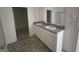 Bathroom boasting double vanity with white cabinets, gray countertop and modern finishes at 4090 Spencer Ln, Stonecrest, GA 30038