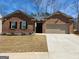 Charming brick home featuring a well-manicured lawn and a two-car garage at 4090 Spencer Ln, Stonecrest, GA 30038