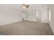Spacious main bedroom featuring plush carpet, a ceiling fan, and ample natural light at 4090 Spencer Ln, Stonecrest, GA 30038