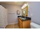 Bathroom featuring double vanity, granite countertop, and decorative mirror at 230 Hidden Brook Trl, Fayetteville, GA 30215