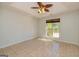 Neutral bedroom with tile flooring and window letting in natural light at 230 Hidden Brook Trl, Fayetteville, GA 30215