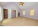 Bright bedroom with vaulted ceiling, ceiling fan, and multiple closets and entryways at 230 Hidden Brook Trl, Fayetteville, GA 30215