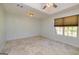 Large bedroom with a ceiling fan, a window with blinds, and neutral walls and flooring at 230 Hidden Brook Trl, Fayetteville, GA 30215