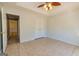 Neutral bedroom with closet, ceiling fan, tile floor, and ensuite door at 230 Hidden Brook Trl, Fayetteville, GA 30215