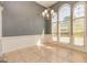 Bright dining room with large windows, stylish lighting fixture, and neutral paint at 230 Hidden Brook Trl, Fayetteville, GA 30215