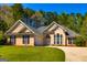 Inviting single-Gathering home with a well-manicured lawn, an attached garage, and a symmetrical facade at 230 Hidden Brook Trl, Fayetteville, GA 30215