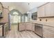 Open kitchen featuring stainless appliances, granite counters, eat-in island, and wood flooring at 230 Hidden Brook Trl, Fayetteville, GA 30215