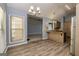 This open-concept kitchen features modern appliances, a breakfast bar, and hardwood floors at 230 Hidden Brook Trl, Fayetteville, GA 30215