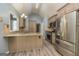Kitchen featuring stainless steel appliances, wood flooring, granite counters, and light wood cabinets at 230 Hidden Brook Trl, Fayetteville, GA 30215