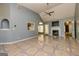 Spacious living room with a fireplace, tiled floors, neutral paint, and access to multiple rooms at 230 Hidden Brook Trl, Fayetteville, GA 30215