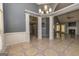 Spacious Living room featuring tiled floors, columns, and neutral paint with entryways to other rooms at 230 Hidden Brook Trl, Fayetteville, GA 30215