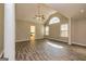 Bright living room has vaulted ceiling, large window, and modern hardwood floors at 230 Hidden Brook Trl, Fayetteville, GA 30215