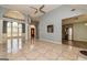 Open-concept living space with tiled floors, large windows, and access to other rooms at 230 Hidden Brook Trl, Fayetteville, GA 30215