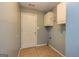 Functional mud room with tiled flooring, a utility sink, and built-in cabinets at 230 Hidden Brook Trl, Fayetteville, GA 30215