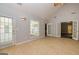 Sunny sun room features glass doors, vaulted ceiling, and access to the backyard at 230 Hidden Brook Trl, Fayetteville, GA 30215